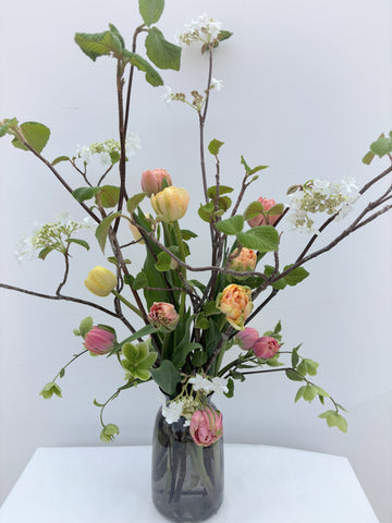 Bouquet of tulips and viburnum from Quebec in vase