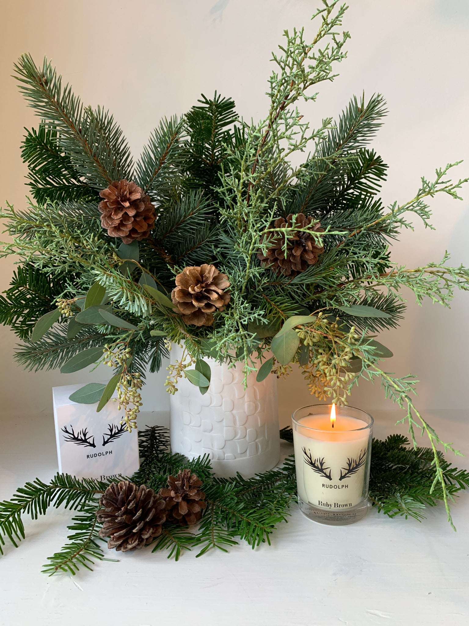 Bouquet of winter greens and RUBY BROWN scented candle